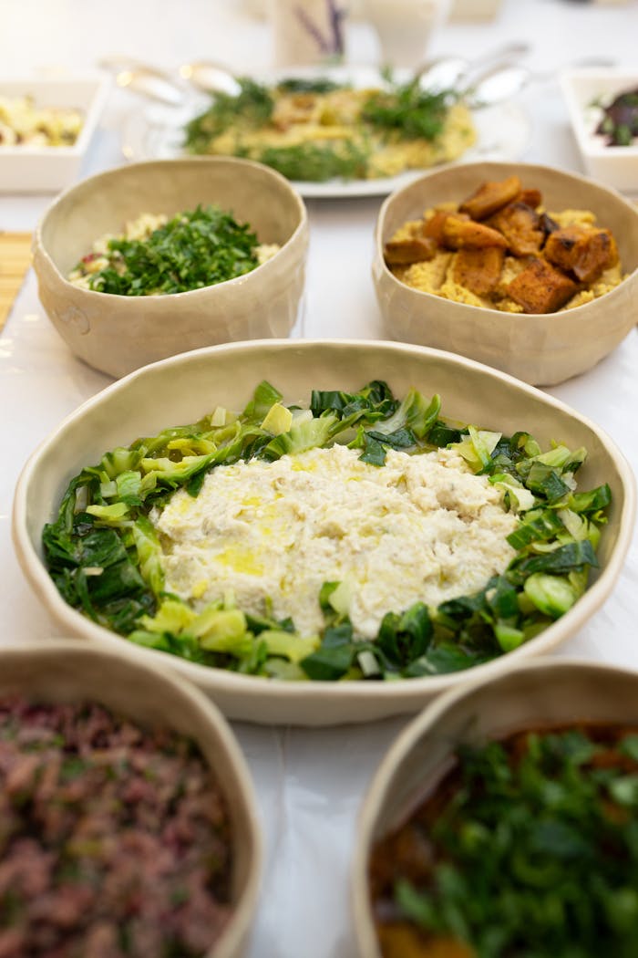 A colorful assortment of vegan bowls featuring vibrant vegetables and grains, shot in high angle.